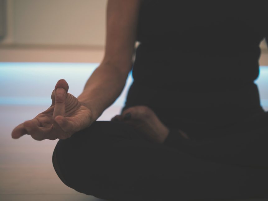 crossed leg yoga seated position with yoga mudra