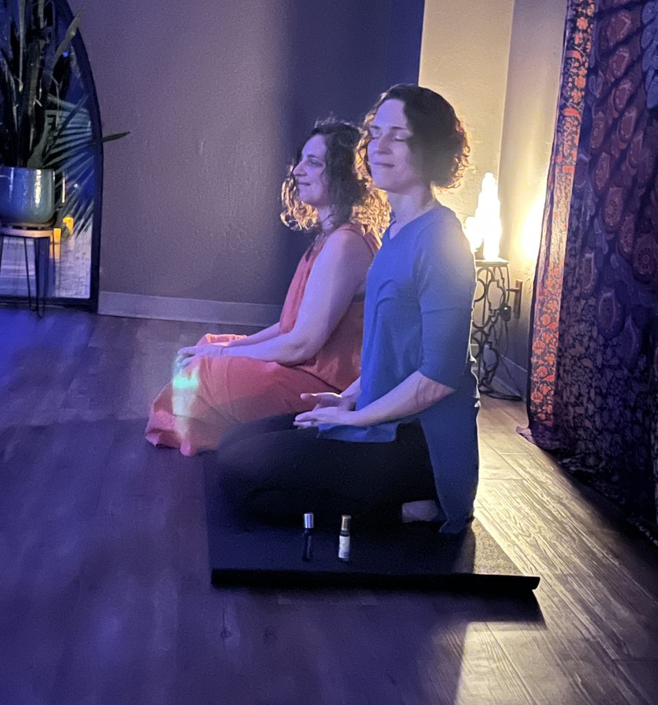 Dual Reiki & Sound Healing Featuring Jaimie Gunn, LMT and Numina Gunn Two women sitting in a meditative pose. 