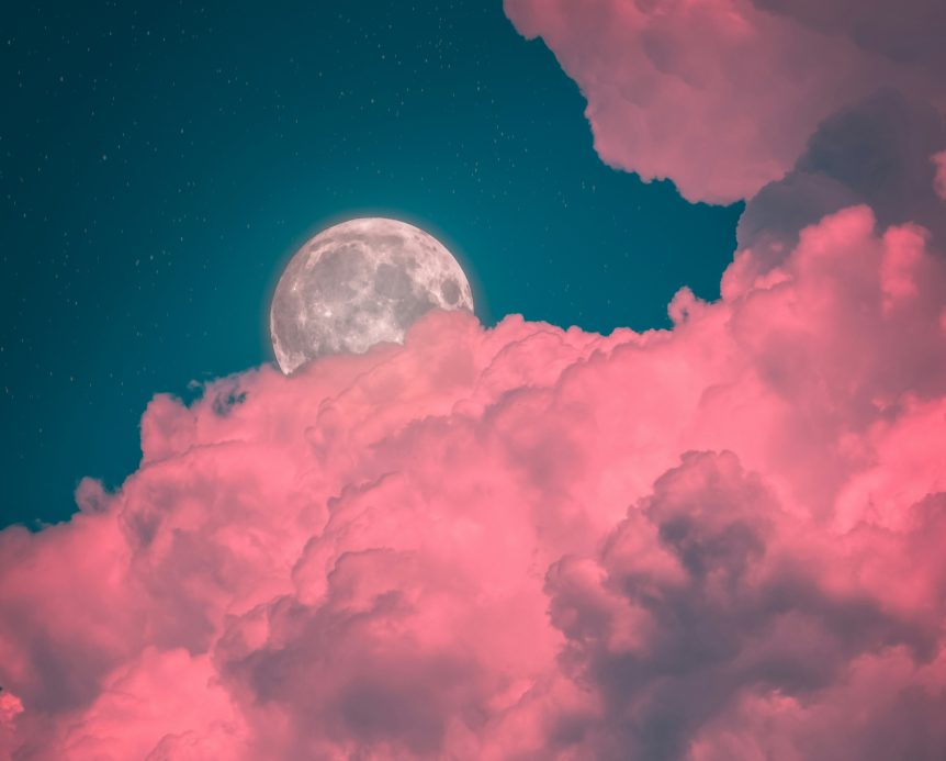 Pink clouds with full moon behind it